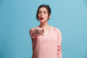 Image showing The overbearing business woman point you and want you, half length closeup portrait on blue background.