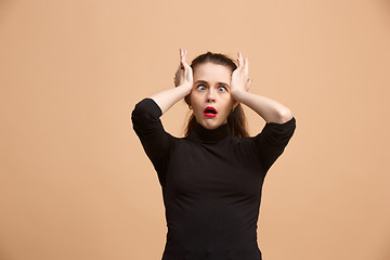 Image showing Beautiful woman in stress isolated on pastel