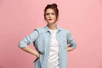 Image showing Portrait of an angry woman looking at camera isolated on a pink background