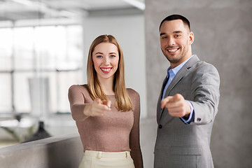 Image showing businesswoman and businessman pointing at you
