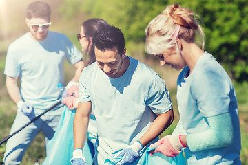 Image showing volunteers with garbage bags cleaning park area