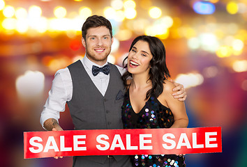 Image showing happy couple with red sale sign