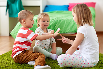 Image showing kids playing rock-paper-scissors game at home