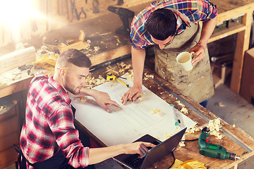 Image showing carpenters with laptop and blueprint at workshop