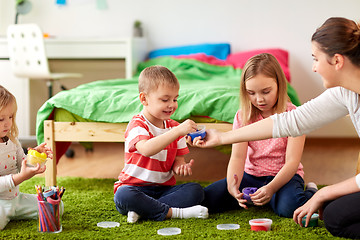 Image showing kids and mother with modelling clay or slimes