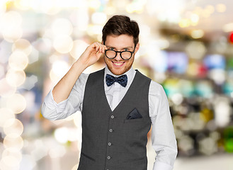 Image showing happy man in suit and eyeglasses over lights