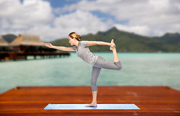 Image showing woman making yoga lord of the dance pose outdoor