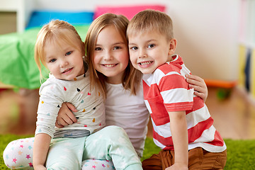 Image showing happy little kids hugging at home