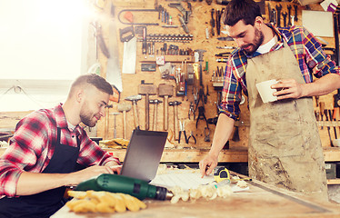 Image showing carpenters with laptop and blueprint at workshop