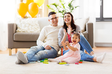 Image showing baby girl with parents clapping hands at home