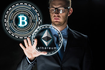 Image showing businessman with ethereum and bitcoin holograms