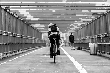 Image showing Man riding his bike in the cycling lane on Williamsburg Bridge, Brooklyn, New York City.