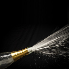 Image showing champagne splashing out of the bottle