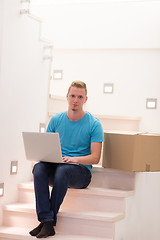 Image showing young man sitting in stairway at home