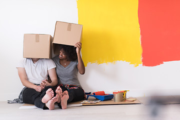 Image showing young multiethnic couple playing with cardboard boxes