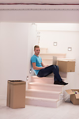 Image showing young man sitting in stairway at home