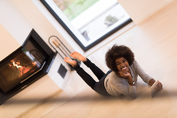 Image showing black women using tablet computer on the floor