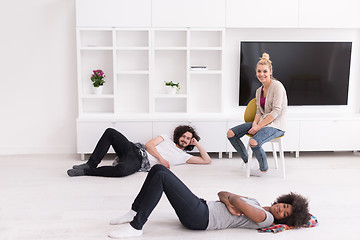 Image showing multiethnic group of people relax in their new apartment