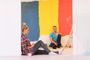 Image showing Happy young couple relaxing after painting