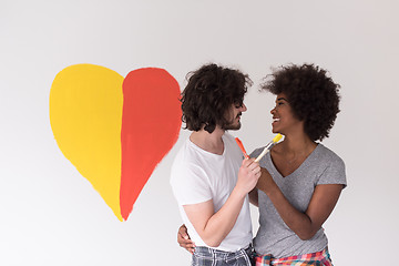 Image showing couple with painted heart on wall