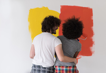 Image showing multiethnic couple painting interior wall