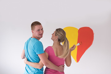 Image showing couple are painting a heart on the wall