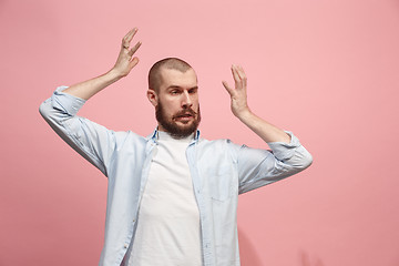 Image showing Beautiful man in stress isolated on pink