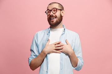 Image showing The happy business man standing and smiling against pastel background.