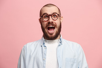 Image showing Beautiful man looking suprised isolated on pink