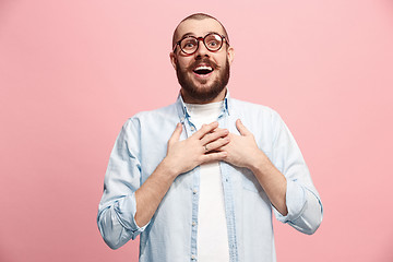 Image showing The happy business man standing and smiling against pastel background.