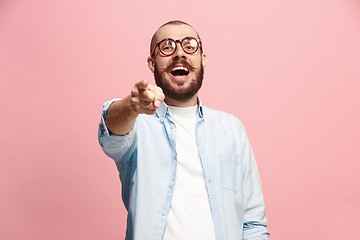 Image showing The happy business man point you and want you, half length closeup portrait on pink background.