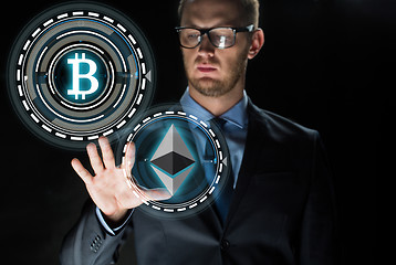 Image showing businessman with cryptocurrency holograms