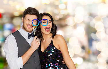 Image showing happy couple with party glasses over lights