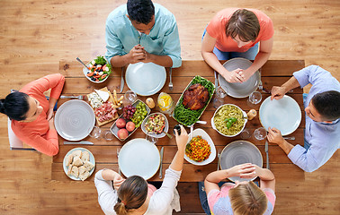 Image showing group of people eating at table with food