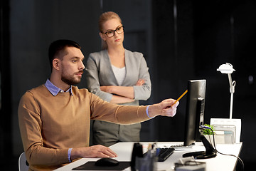 Image showing business team with computer working late at office