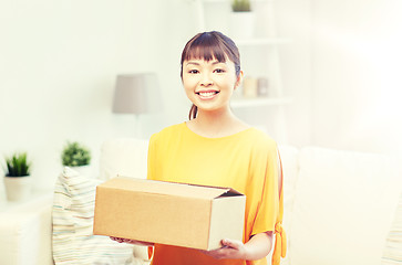 Image showing happy asian young woman with parcel box at home