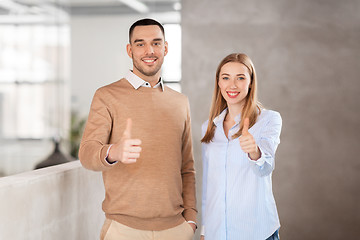 Image showing businesswoman and businessman showing thumbs up