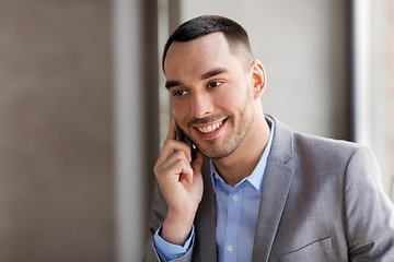 Image showing businessman calling on smartphone at office