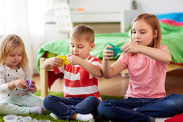 Image showing kids with modelling clay or slimes at home