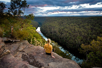 Image showing Female enjoying river views from cliff top