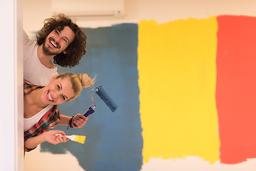 Image showing portrait of a couple painting interior wall