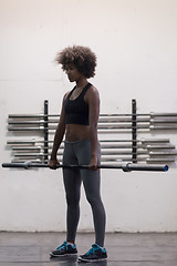 Image showing black woman lifting empty bar