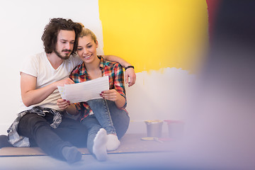 Image showing Happy young couple relaxing after painting