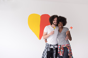 Image showing couple with painted heart on wall