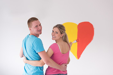 Image showing couple are painting a heart on the wall