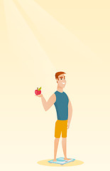 Image showing Man standing on scale and holding apple in hand.