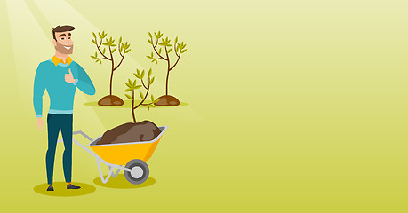 Image showing Man pushing wheelbarrow with plant.