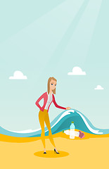 Image showing Woman showing plastic bottles under sea wave.