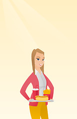 Image showing Woman holding tray full of fast food.