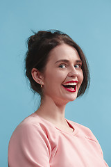 Image showing The happy business woman standing and smiling against blue background.